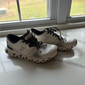 On Running White and Black Athletic Shoes